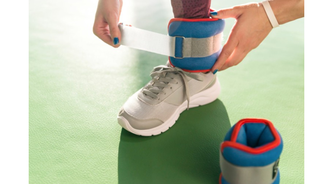 woman putting ankle weights before excercise