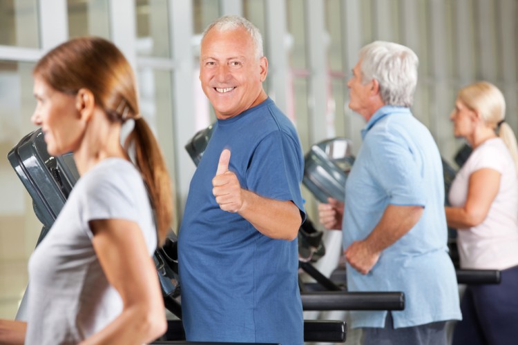 Happy seniors using treadmill for excercise