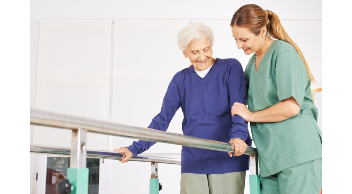 physiotherapist helping old senior woman